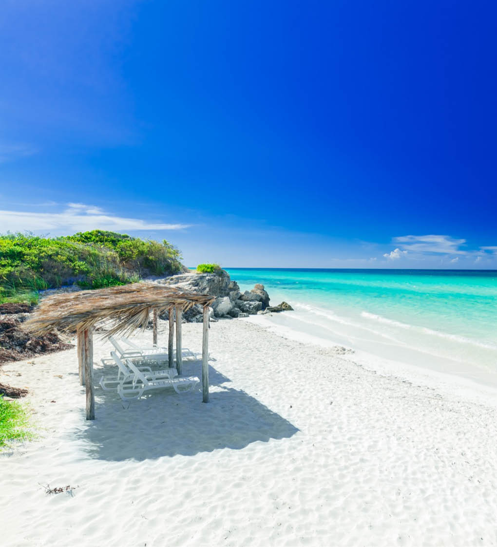 stunning, amazing inviting view of tropical white sand beach and tranquil turquoise ocean on dark deep, blue sky background at Cayo Coco Cuban island, sunny summer beautiful day