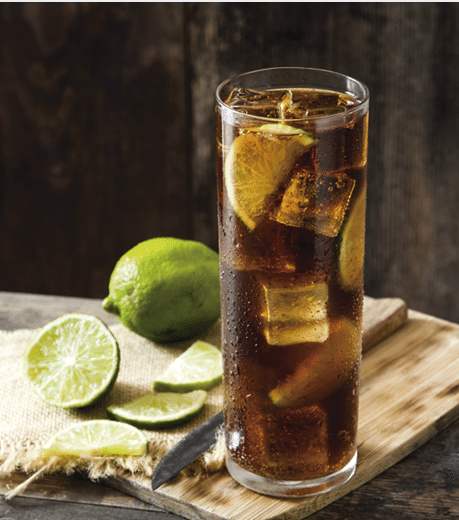 Close up cuba libre. Cocktail with rum, lime and ice on white background.