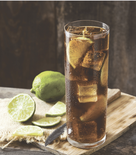 Close up cuba libre. Cocktail with rum, lime and ice on white background.